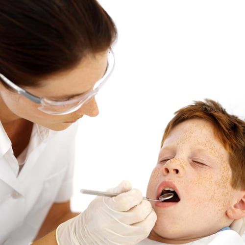 Dentsist checking patient